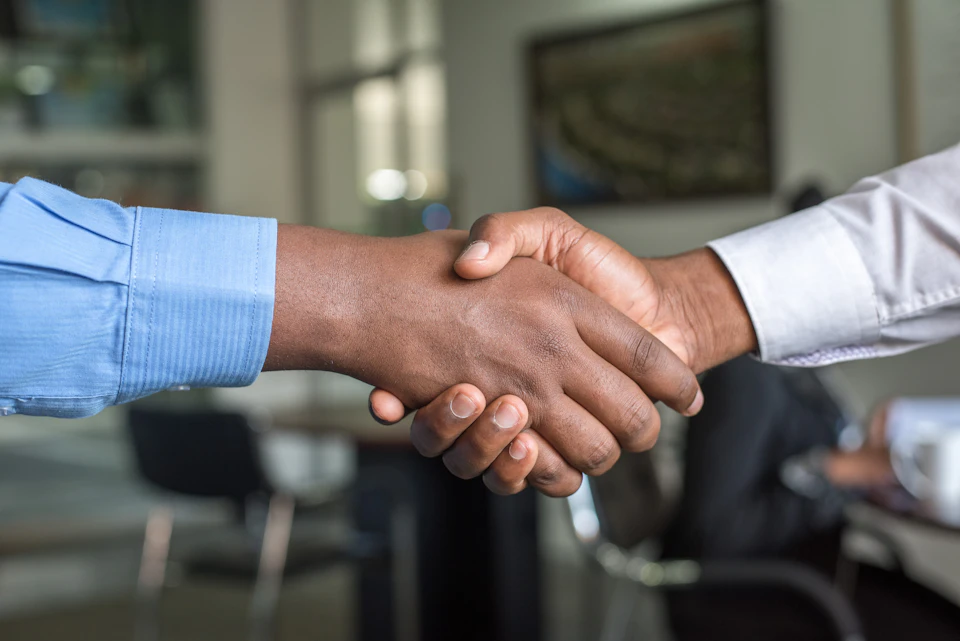 Aperto de mãos em ambiente corporativo
